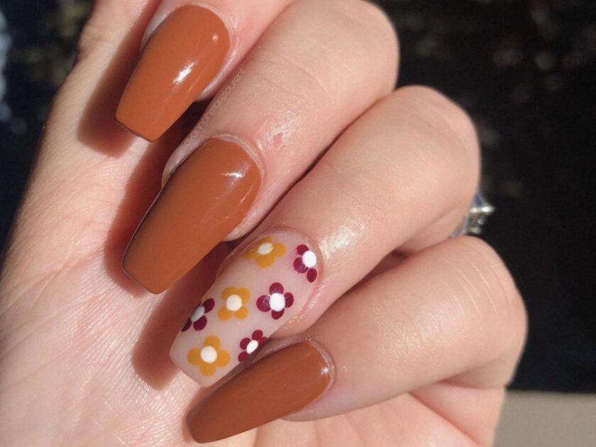Solid-Color Manicure and Minimal Floral Accent in Fall Burnt Orange